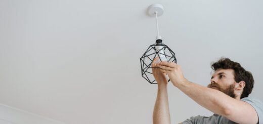 Man screwing light bulb into lamp